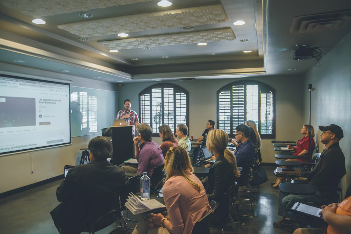 Executive education classroom with professors and MBA students in a business school environment